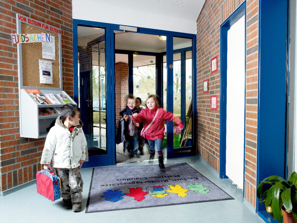Children entering German daycare building.