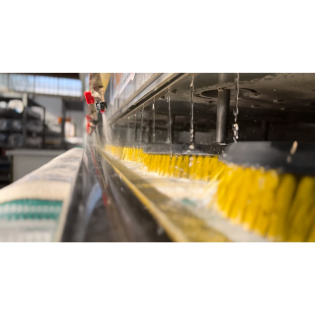 Rug cleaning machine with brushes and water.